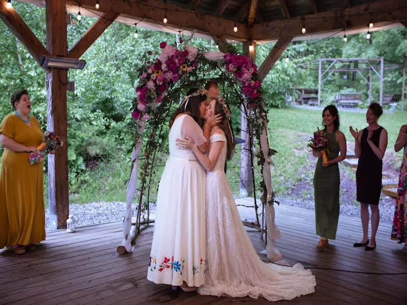 Wedding Couple kissing during ceremony under the Pavilion