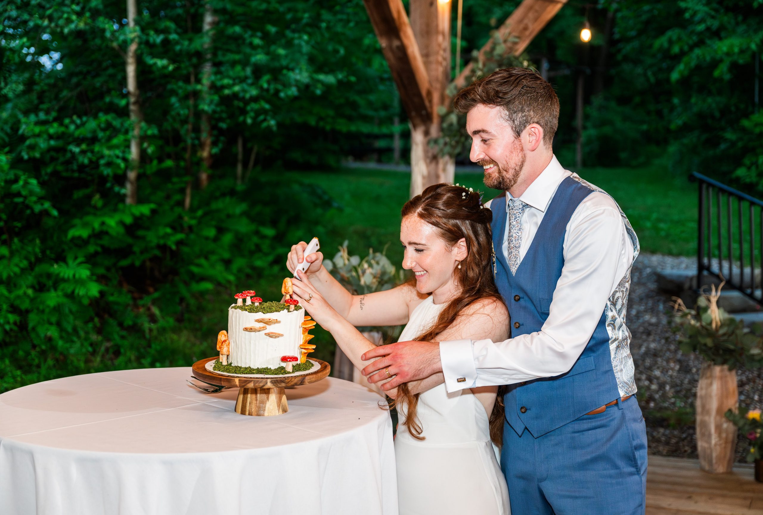 Whimsical Woodland Wedding at Sleepy Hollow Inn 26 Wedding Couple cutting their wedding cake