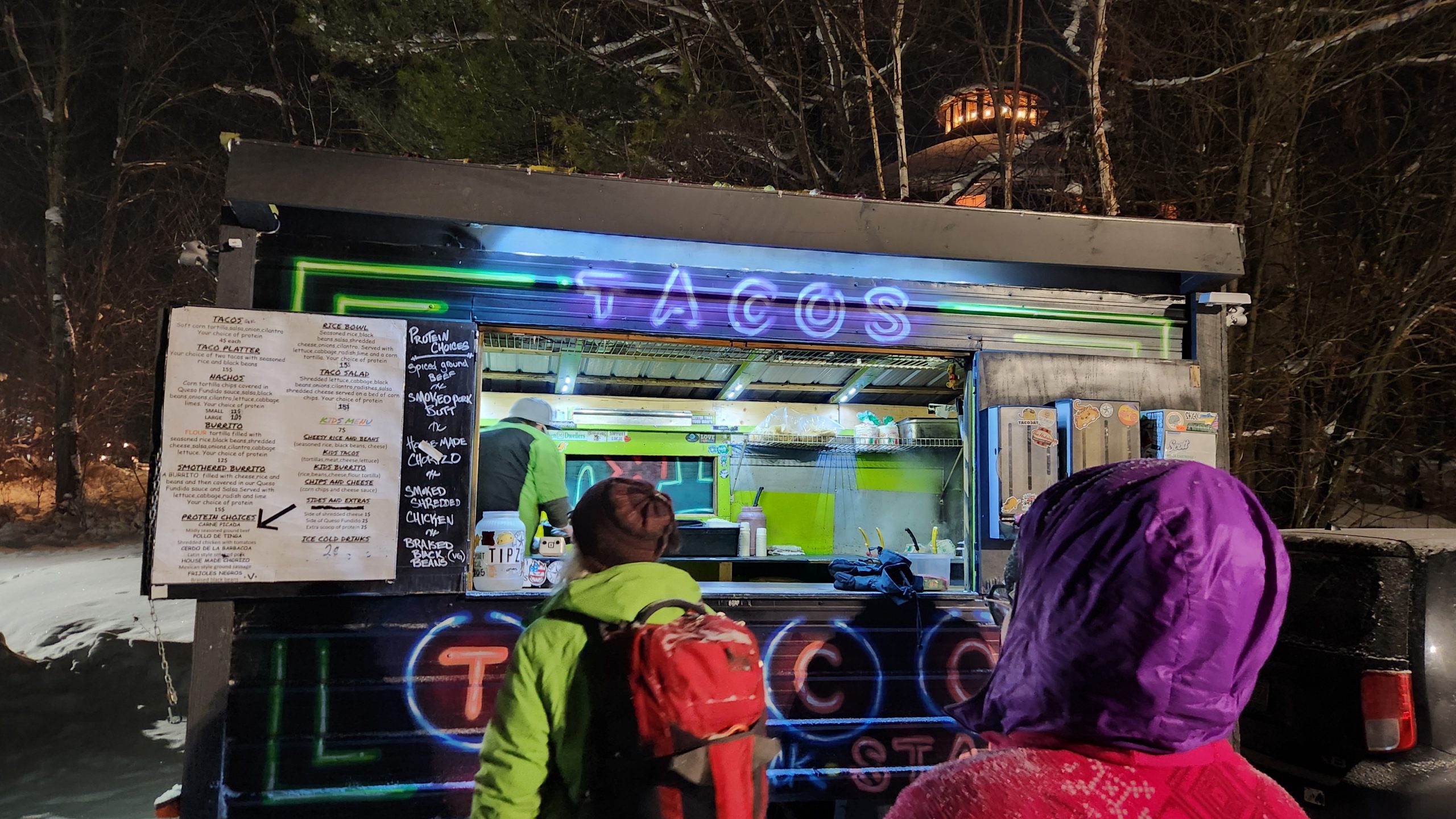 Full moon skiers wait for their tacos.